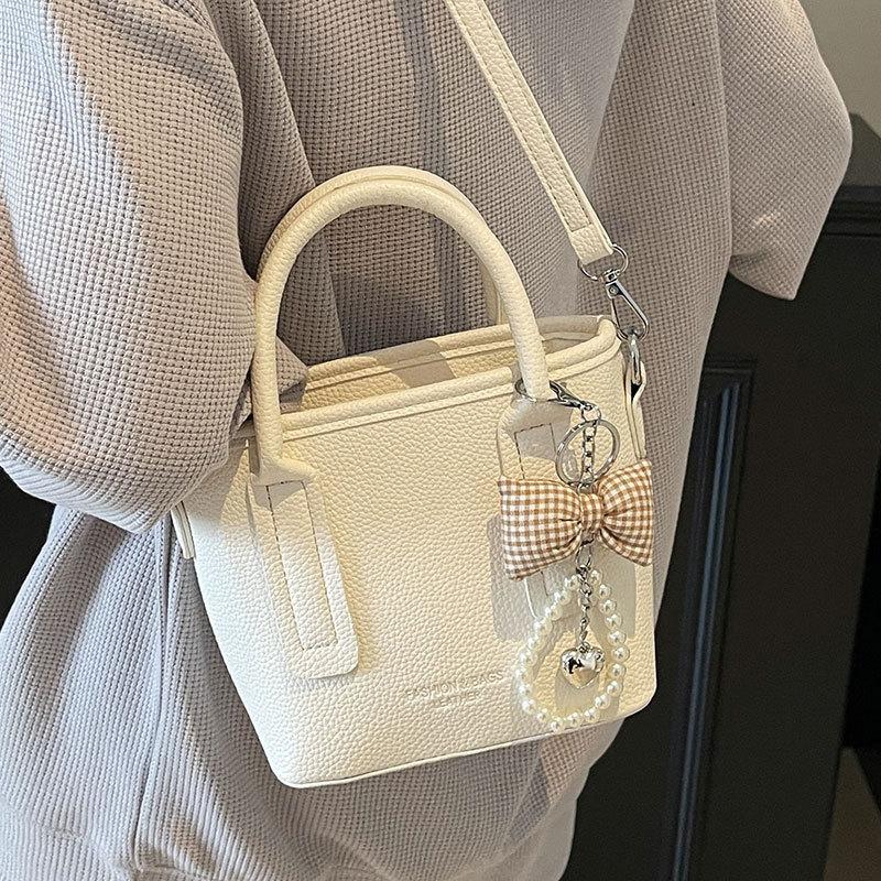 Spring and summer popular solid color simple high quality lychee pattern portable bucket bag women's fashion versatile commuter messenger bag