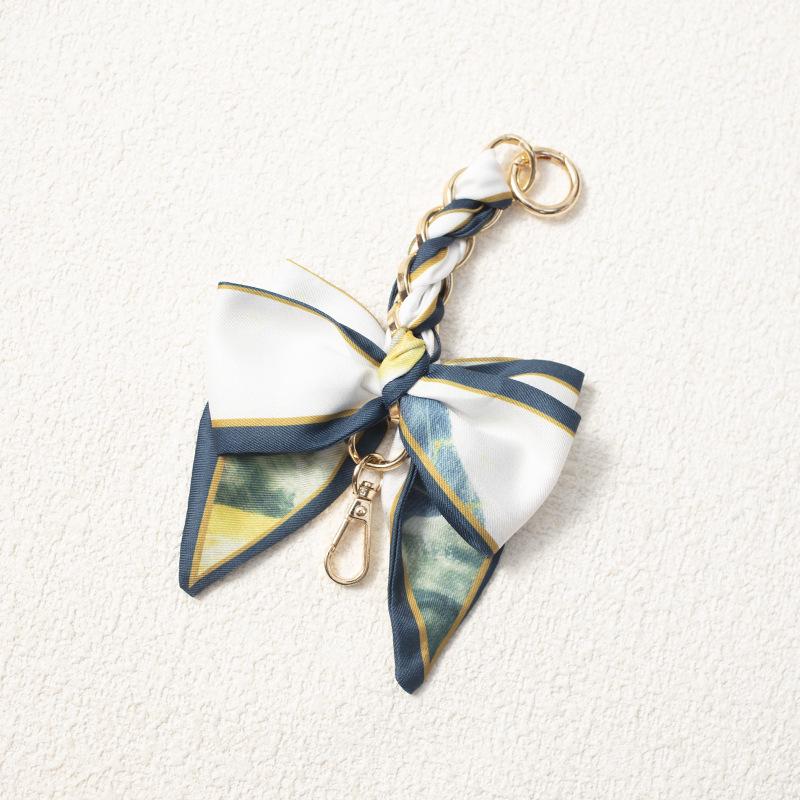 Elegant Hand-Woven Scarf Chain with Bow Decoration Pendant for Bag Strap Modification.