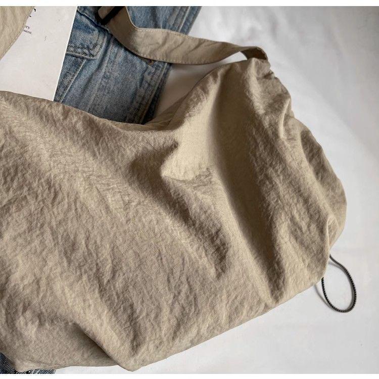 Japanese-Style Waterproof Nylon Dumpling Crossbody Bag: Sporty, Large-Capacity Tote for Men & Women, Ideal for Cycling & Relaxed Shoulder Wear.