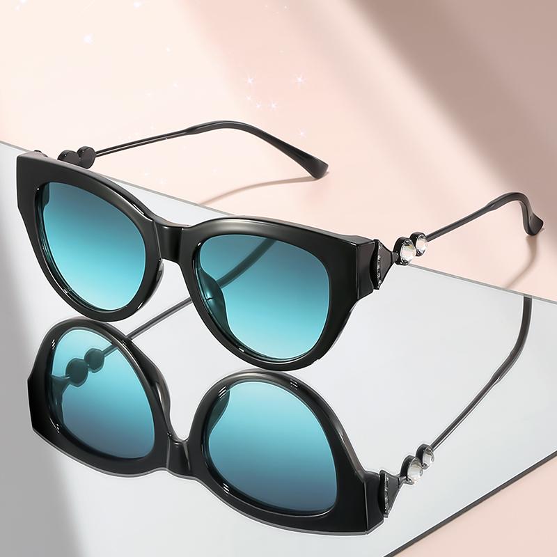 New cat-eye sunglasses with diamond-like embellishments on metal temples for a high-end versatile look