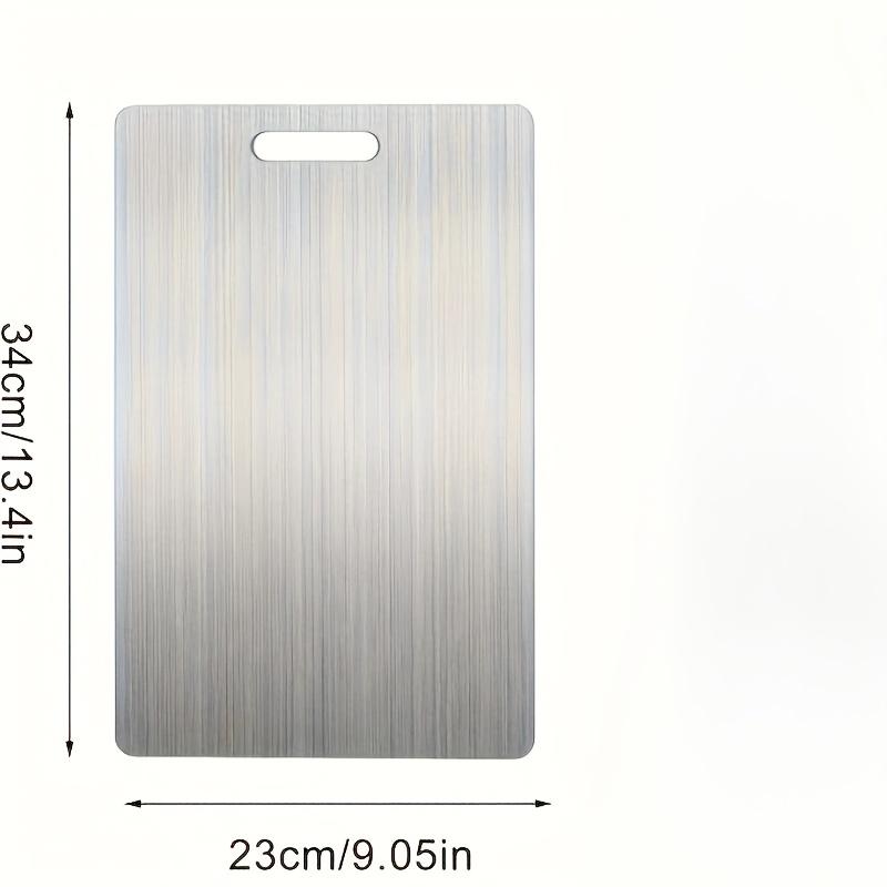 Premium double - sided titanium chopping board. Food - grade steel, durable, easy - clean, rustproof. Ergonomic handle, sleek look, great for kitchen.