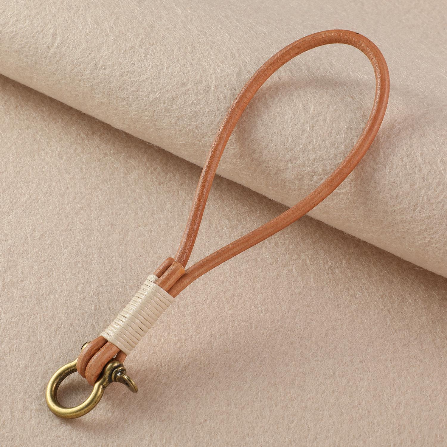 Retro Cowhide Keychain with Woven Rope and Horseshoe Buckle - Simple Bag Charm for Students and Cameras