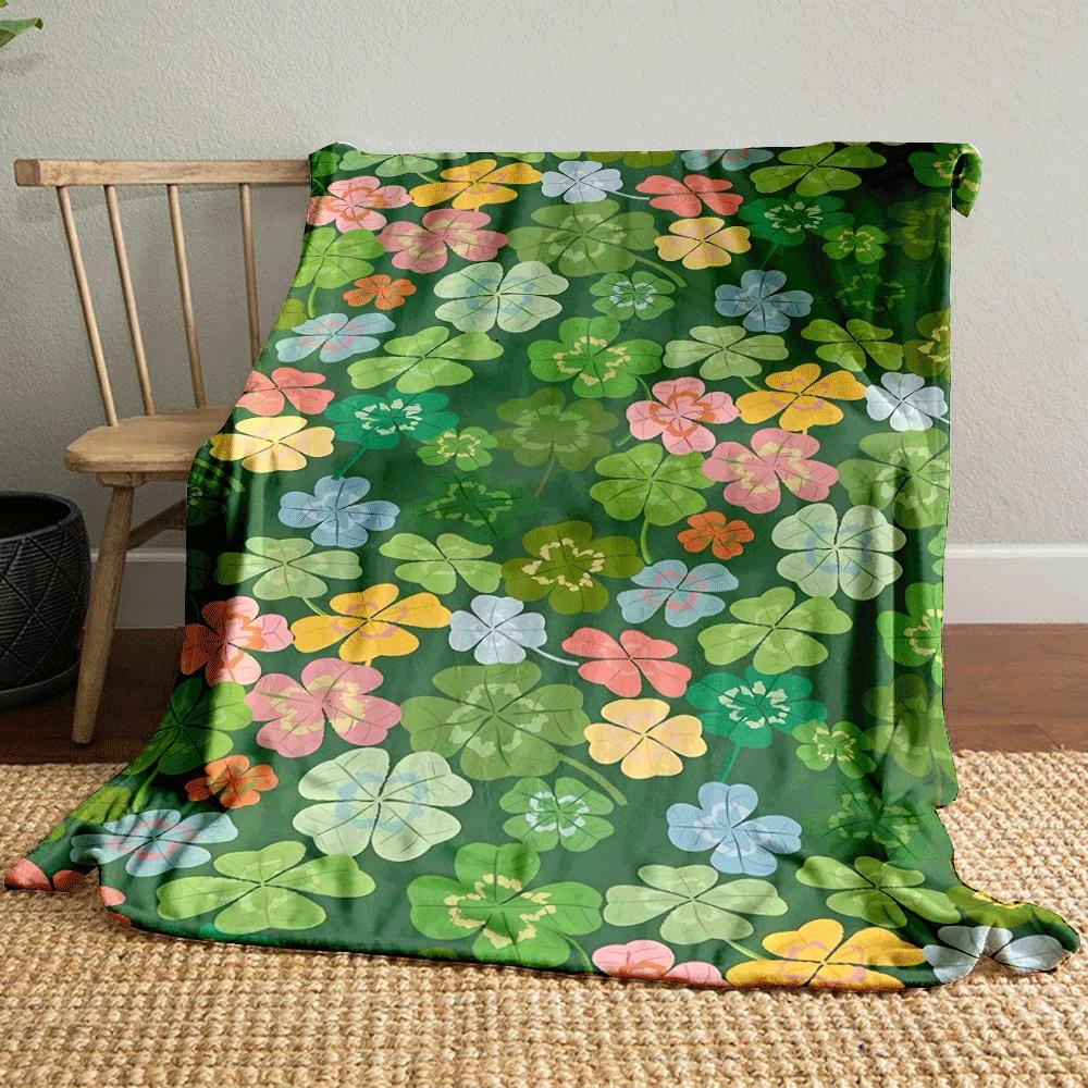 Colorful clovers and flowers scattered on a green background. for all seasons blanket lunch break throw gift