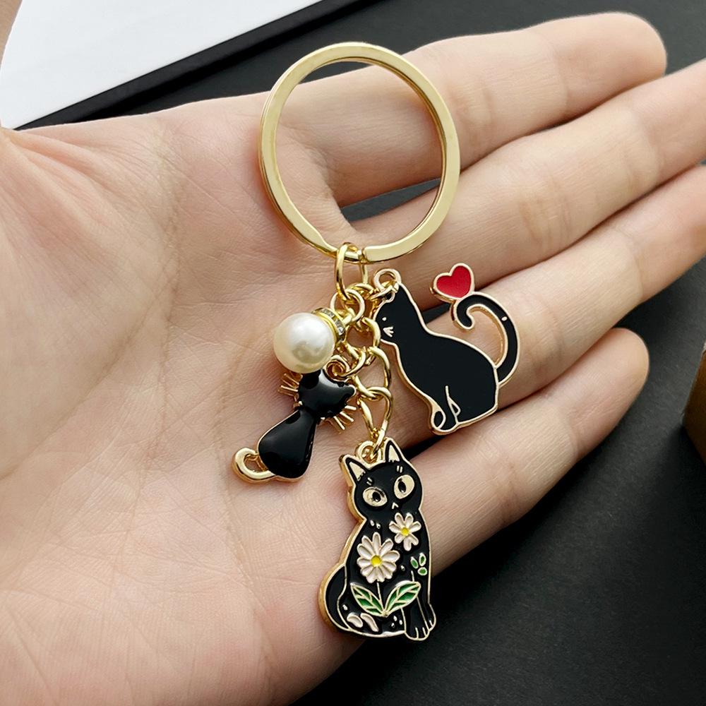 Black Cat Pearl Heart Keychain Charm with Cartoon Drip Oil Design