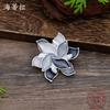 New enamel color hollow geometric camellia magnetic brooch women's fashion versatile three-dimensional flower corsage