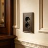Electroplated Wall Outlet Cover Plate with Stepped Decorative Border for Indoor Wall Detail and a Unified Metal Finish