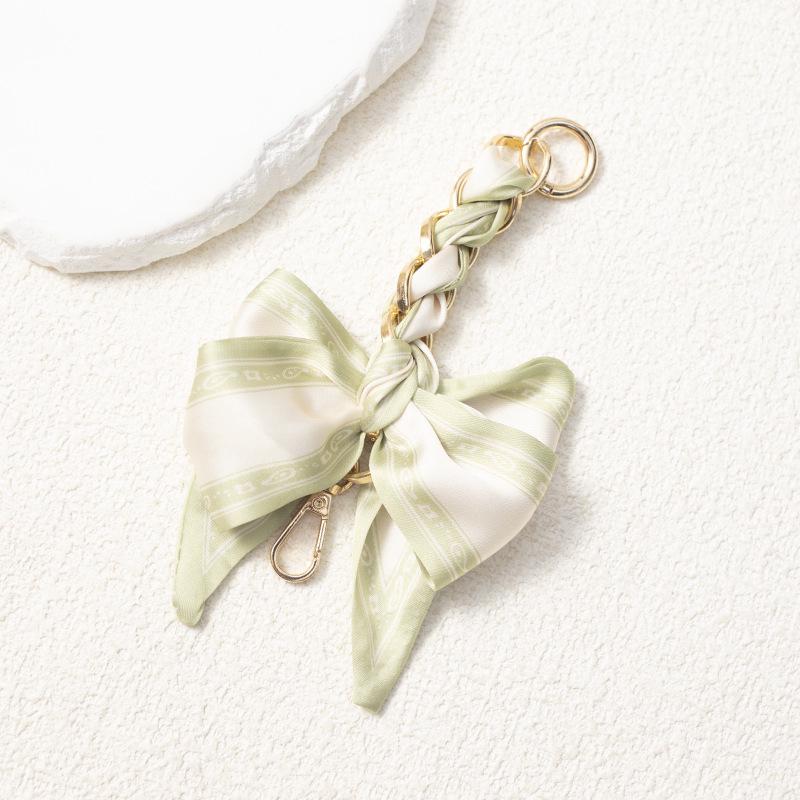 Elegant Hand-Woven Scarf Chain with Bow Decoration Pendant for Bag Strap Modification.