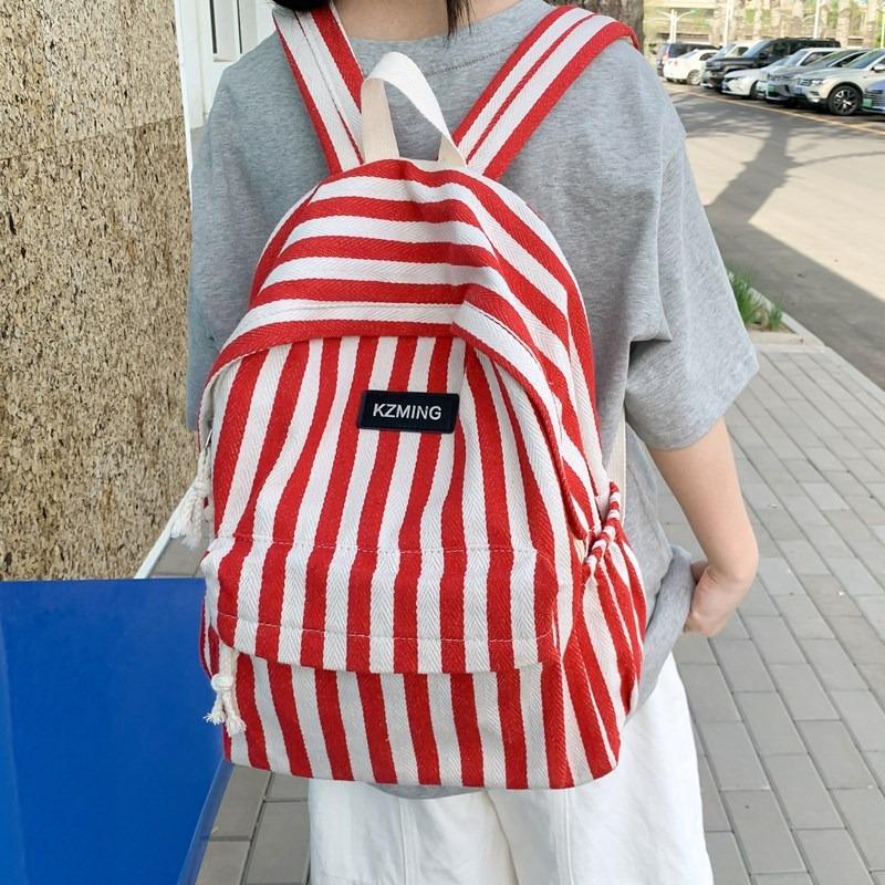High-value college style striped backpack for junior high school students, casual, simple, lightweight and large-capacity backpack.