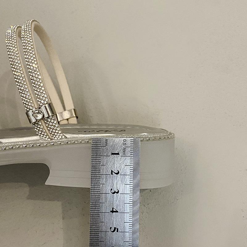 Beautiful slippers female 2025 summer wear new Internet celebrity butterfly rhinestone one-word drag fairy wind beach two sandals