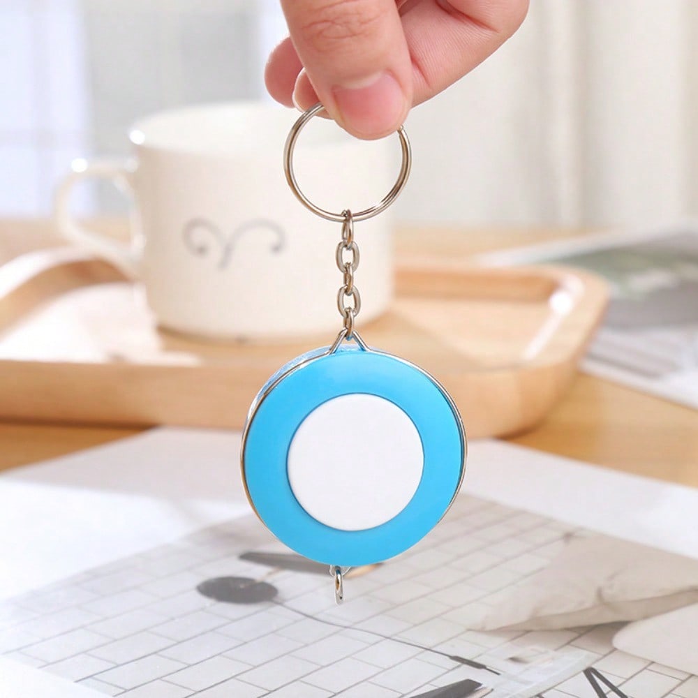 A Stylish Keychain Measuring Tape In Vibrant Colors, Featuring A 1.5-Meter Retractable Design, Perfect for Measuring Clothing Sizes