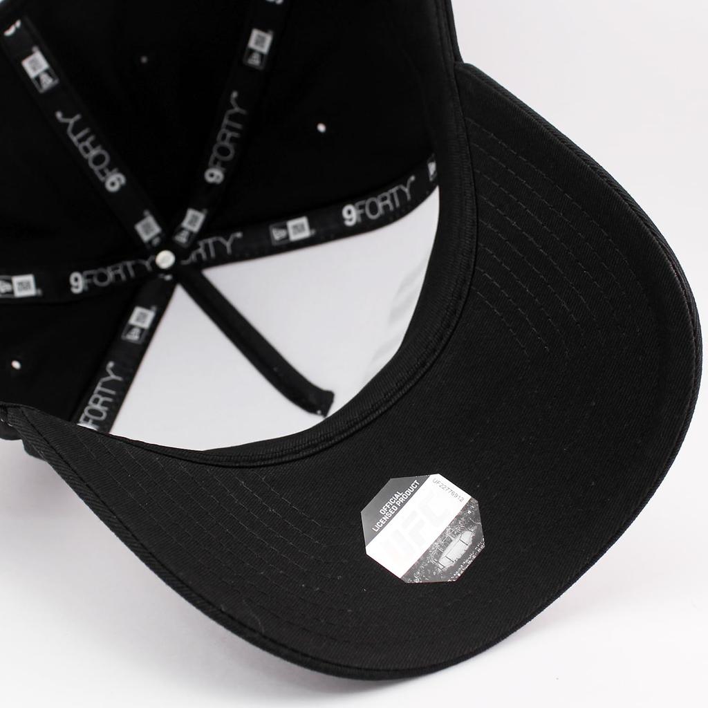 New Era 9FORTY Snapback Cap in collaboration with the Available in white and Adjustable size for men and UFC. black. women. [Used]