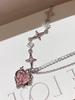 A Single-piece Pink, Understated Luxury Necklace for Women. Features a Minimalist Style with Diamond, Heart, and Star Patterns,
