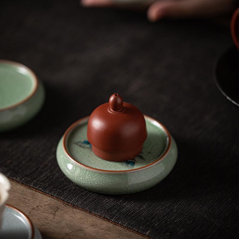 Ceramic Tea Set Coaster: Anti-Scald Round Insulation Mat with Mountain and Water Design.