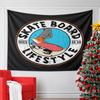 Skateboarder with orange shoes and red board in a circular emblem design. Patterned tapestry for bedroom and living room home decor