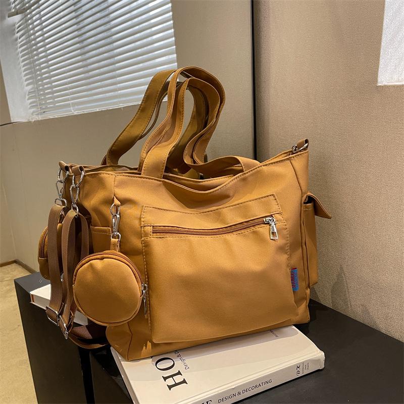 Japanese-Style Canvas Crossbody Bag: Double Pocket, Large Capacity, Women's Tote, Solid Color, Perfect for Students and Commuting.