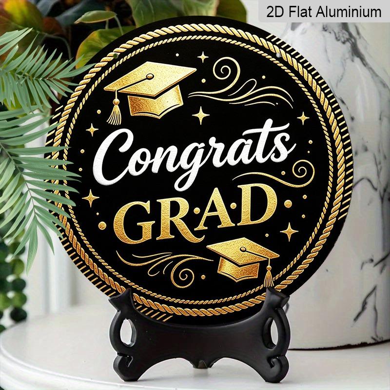 2D Flat Aluminum Graduation-themed Wall Decoration Available in Multiple Sizes Features A Black and Gold Minimalist Graduation Cap Design Making It A
