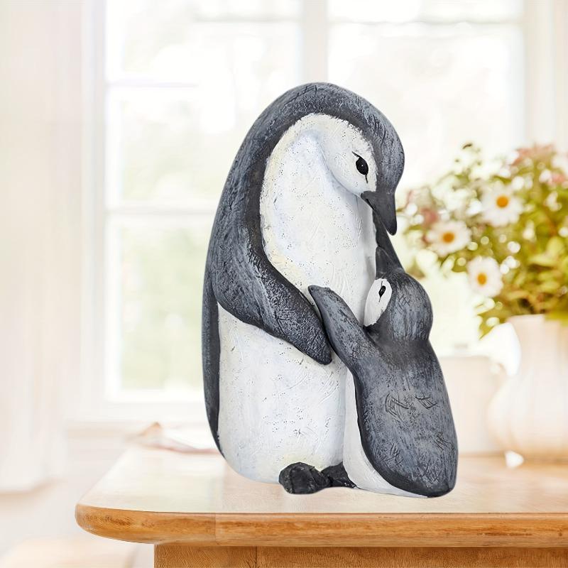 A Set of Two Resin Statues Featuring a Mother And Penguin Showcasing a Creative Family Theme These Can Serve As Decorative Pieces for Home