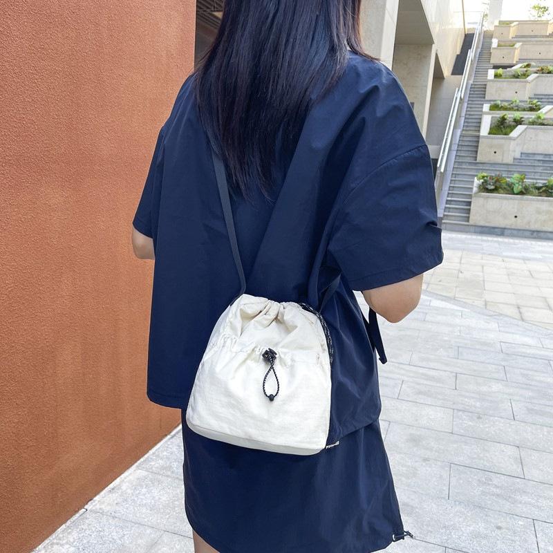 Simple trendy brand small satchel women's lightweight nylon mobile phone bag lazy pleated drawstring messenger bag men's shoulder bag