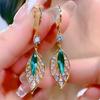 Leaf Shaped Dangle Earrings with Marquise Cut Center Stone and Small Round Accent Stones Gold Tone Metal Drop Earrings for Women
