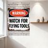 Vintage Weathered Metal Warning Sign with Rust & Chipped Paint - Watch for Flying Tools - Black Oval Border & Red Interior - Hom
