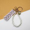 Trending 2025 Keychain Set Fashion Minimalist Pearl Car Keychain Woven Stripe Bag Charm Elegant Women Keychain Organizer Gift