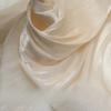 Soft shiny creased organza fabric with a smooth texture suitable for wedding dresses formal gowns and designer clothing fabrics