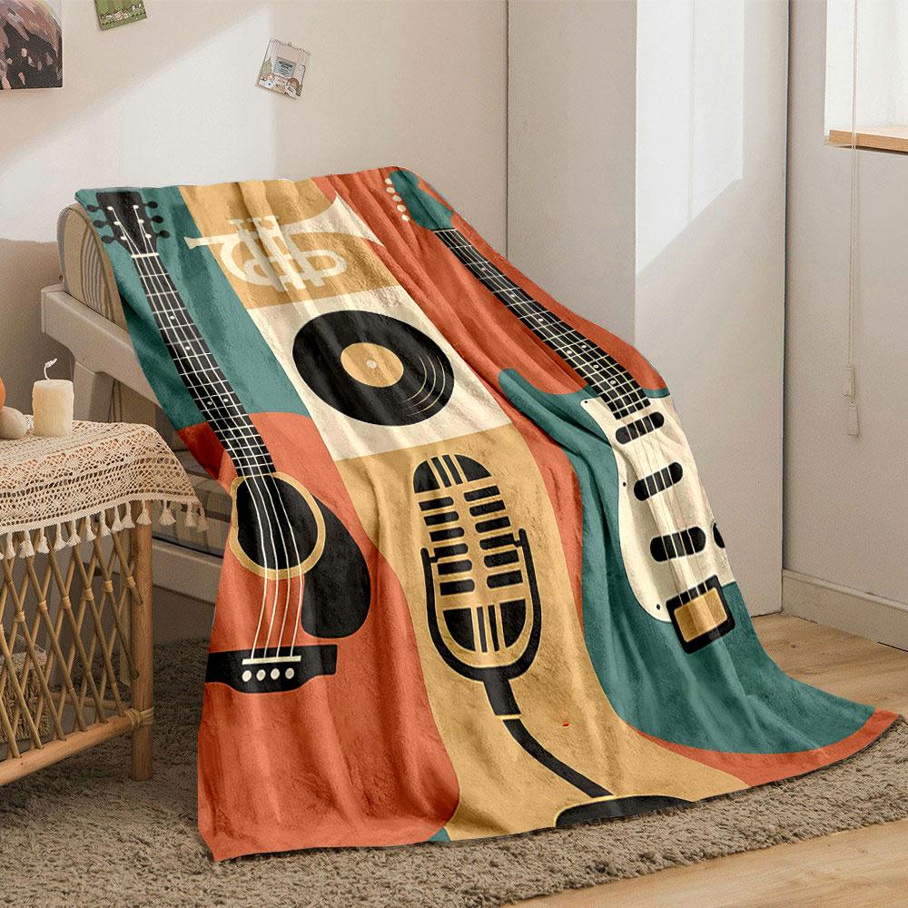 The pattern features guitars, a trumpet, a microphone, and a vinyl record. for all seasons blanket lunch break throw gift