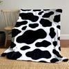 Black irregular spots on a white background resembling a cow print. for all seasons blanket lunch break throw gift
