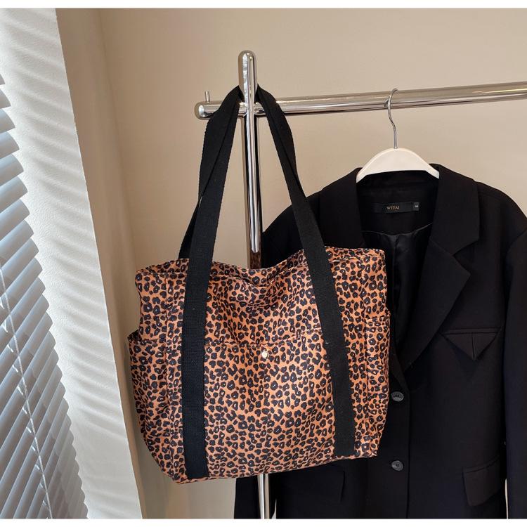 Leopard Print Canvas Tote: Large Capacity Autumn Shoulder Bag for Women, Versatile for College and Commute.