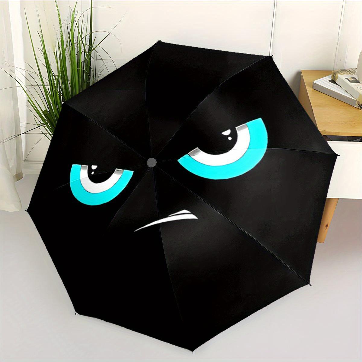 

A Compact Folding Umbrella Featuring an Angry Cartoon Face. It S a Convenient Outdoor Accessory Suitable for Any Season, Making It a Great G