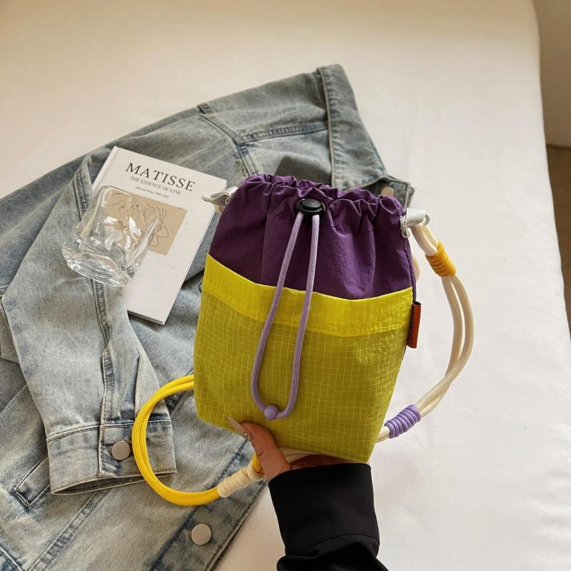 

2025 splicing contrasting color bundle mouth bag creative storage cloth bag shoulder women s bag messenger bag casual fashion small bag