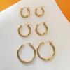 French Retro Gold-Plated Twisted Hoop Earrings - Titanium Steel Studs for Women, European-American Fashion.