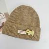 Three-dimensional puppy patch knitted hat female, soft waxy vertical pattern curled edge cold hat, autumn and winter warm wool hat