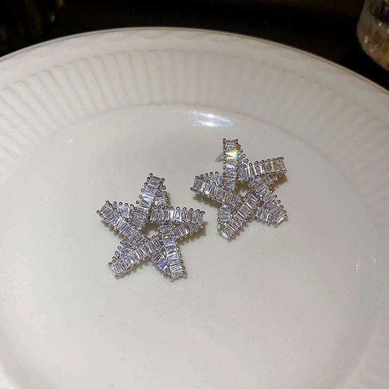 

Silver needle zircon star hollow earrings, European and American exaggerated design studs, niche cold wind temperament earrings