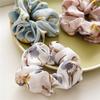 French-style smooth satin scrunchie with floral pattern, versatile elastic hair tie for women, popular on Instagram