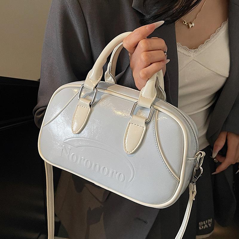 2025 new Korean simple contrasting color portable Boston bag casual commuting versatile foreign style niche messenger women's bag