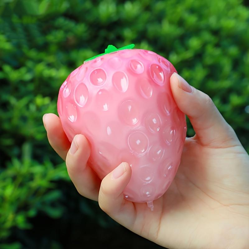1 Simulated Color Changing Strawberry Toy, A Stress Relief Toy That Changes Color In The Sunlight, and A Decompression Rebound