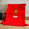 A cartoonish smiling face with big yellow eyes on a red background. for all seasons blanket lunch break throw gift