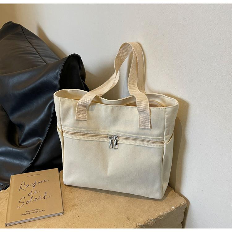 

Large Capacity Street Style Canvas Tote Bag With Zipper Closure And Nylon Lining білий