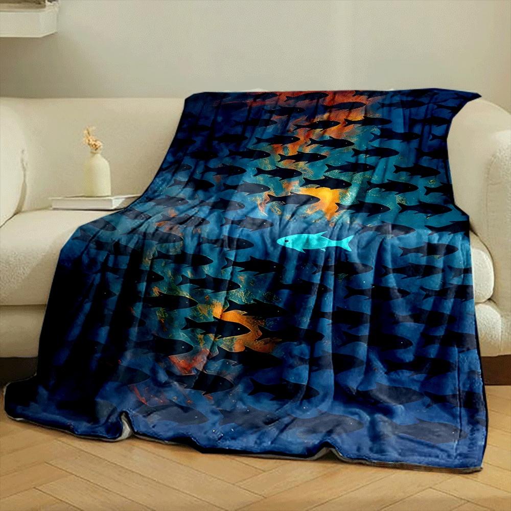 A lone bright fish swims opposite a school of dark fish on a vivid background. for all seasons blanket lunch break throw gift