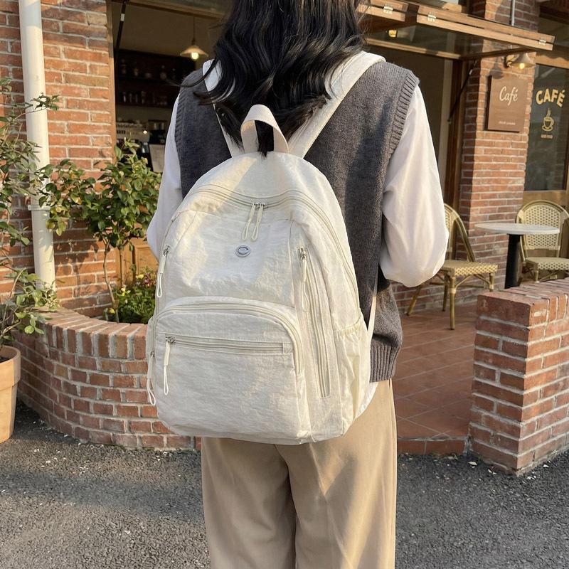 High-value solid color Korean version of the new popular simple fashion versatile light Japanese commuting travel backpack women