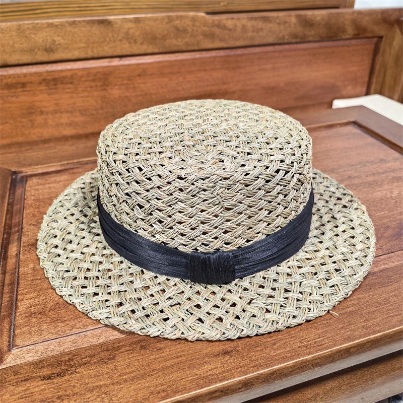 High sense handmade salty grass hollow woven straw hat women's French summer fashion beach hat British flat top hat tide