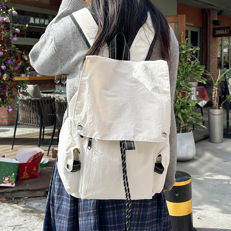 2025 new Korean niche casual simple style solid color backpack women's commuting versatile large-capacity student schoolbag