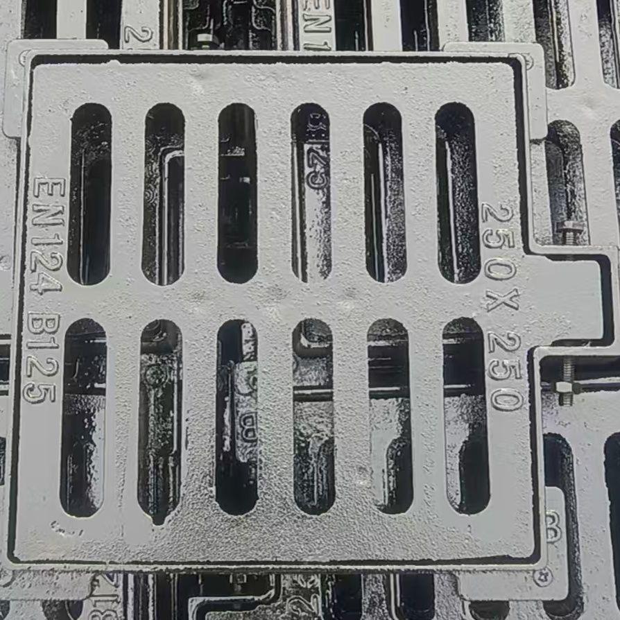 Complete Set: Ductile Iron Rainwater Manhole Cover with Cast Iron Base and Rectangular Sewer Grate.