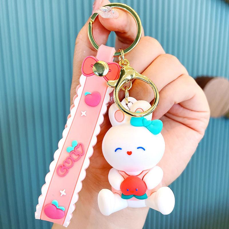 

Bunny White Delightful Keychain Soft Rubber Peach Holding Rabbit Design Peach
