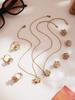 Oumika Oumei Five-Petal Zircon 360° Rotating Jewelry Set: 18K Gold-Plated Earrings, Ring, and Necklace.