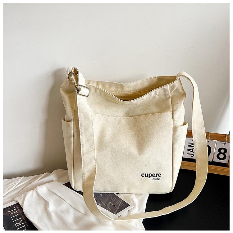 

Японский холст 2025 осень большая вместимость простой модный тренд повседневная холщовая наплечная сумка-мессенджер