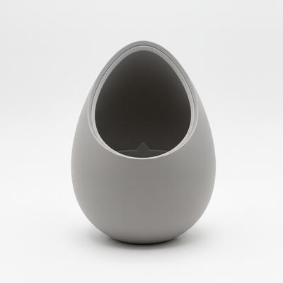 A Modern, Decorative Gray Plant Pot In the Shape of a Nest for Plants.