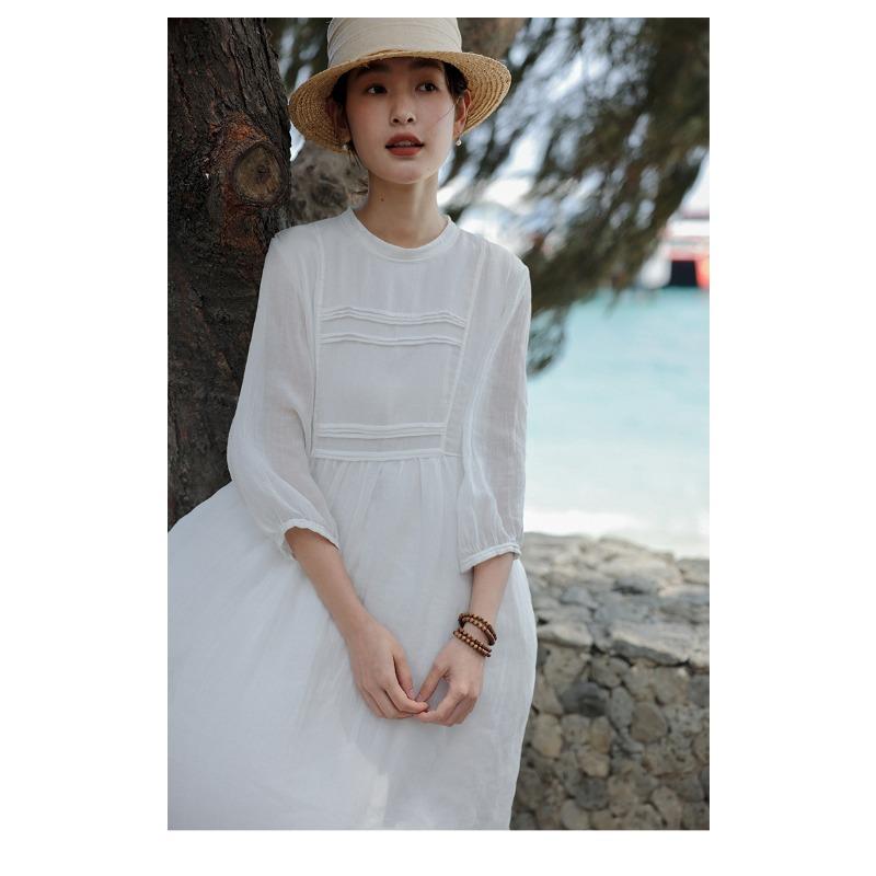 A Woman In A Double Layered Mid Length White Dress