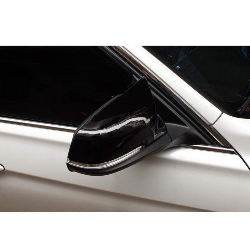 BMW 5 Series F10/F18 Horn Style Rearview Mirror Housing Backup Camera Cover, Glossy Black Carbon Fiber Pattern.